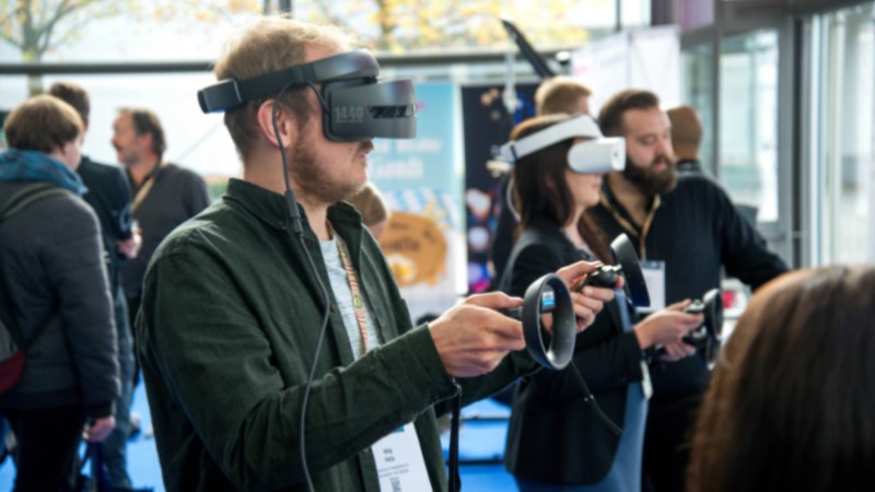 A person using a virtual reality headset and hand controls.