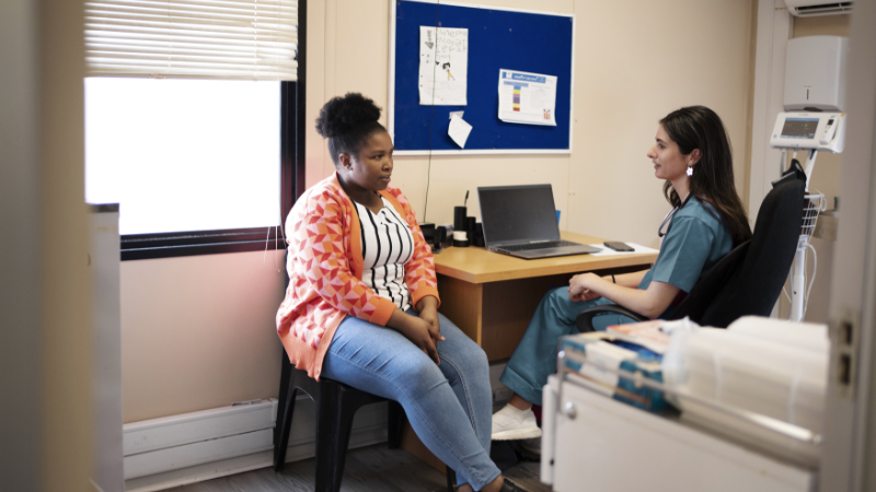 A female health professional talking to a patient.