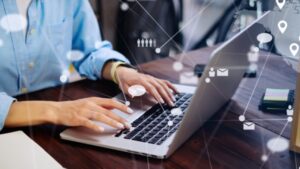 A person typing on a laptop computer.