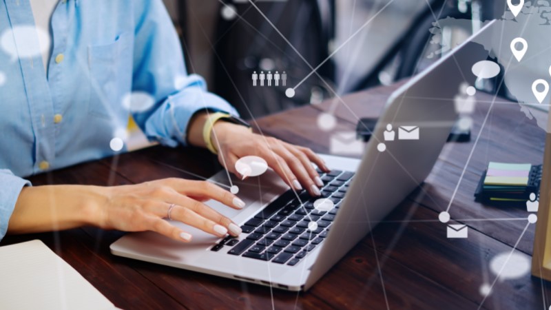 A person typing on a laptop computer.